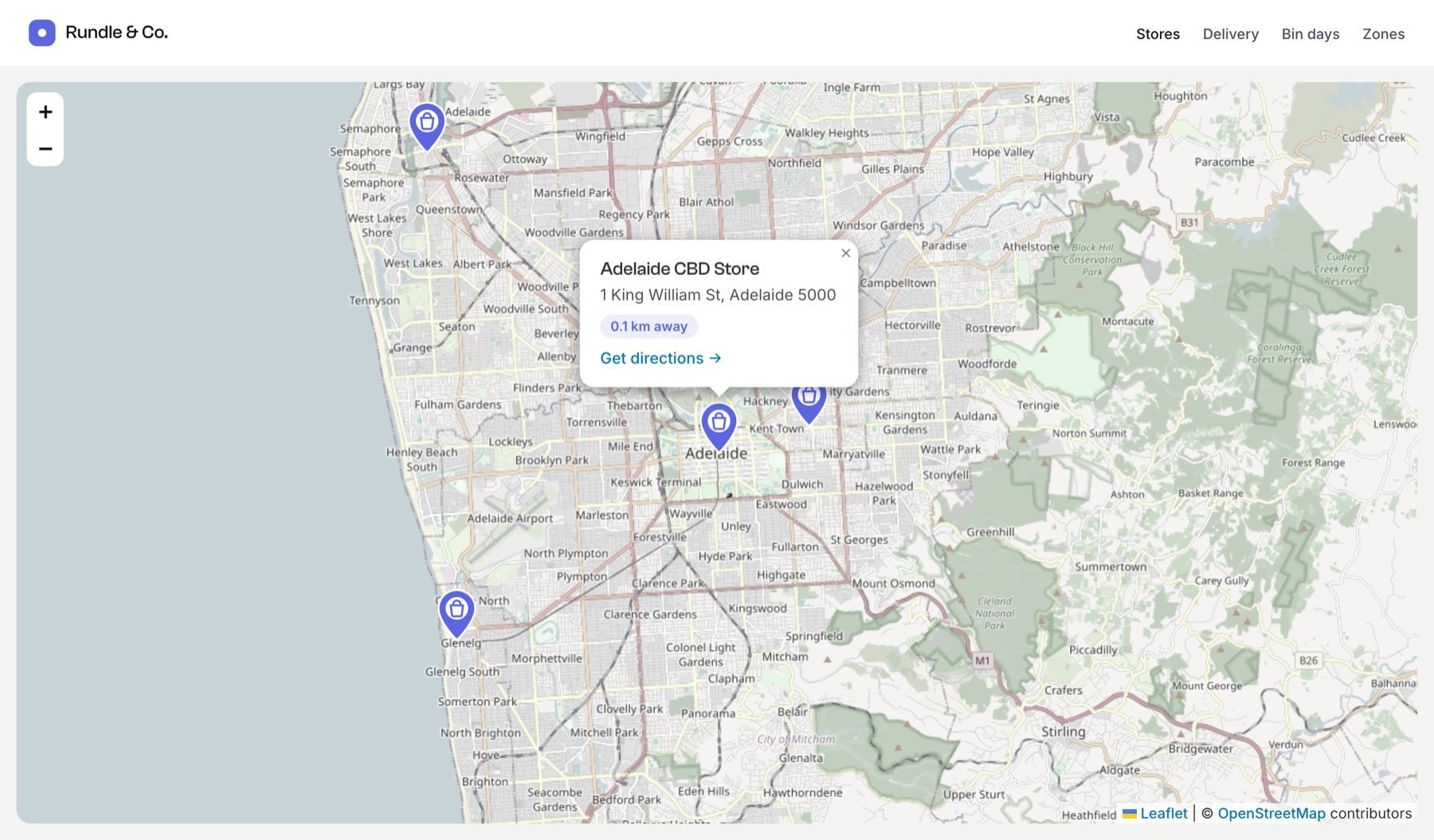 A map of stores with purple custom pins; one pin's info window shows the store name, address, distance and a directions link